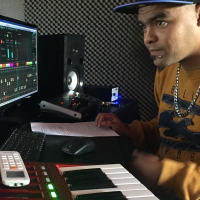 Male Projects Abroad Music Production Intern is recording and mixing in a studio during his Music Production Internship in South Africa. Male Music Production Intern is at a local Recording Studio mixing at a sound desk during his work experience in South Africa.